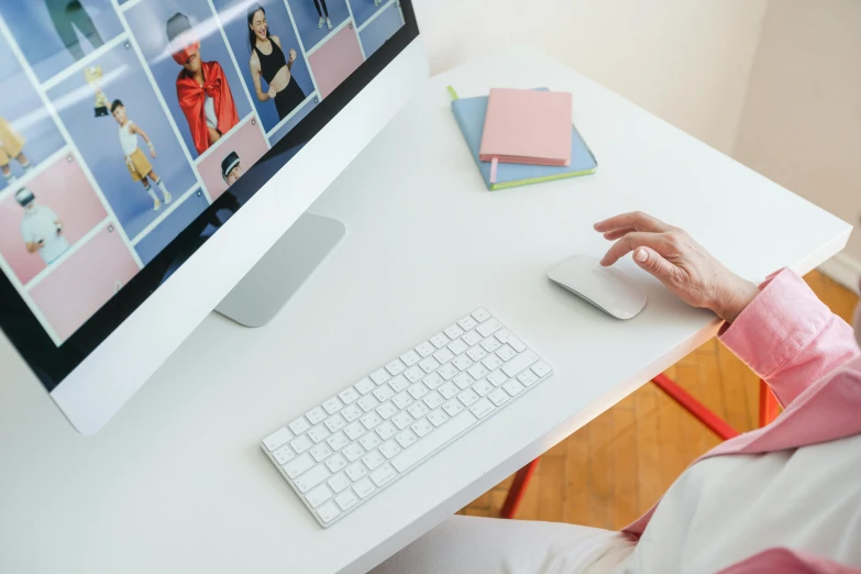 a woman sitting at a desk using a computer, trending on pexels, like a catalog photograph, white mouse technomage, clothing photography, rounded corners