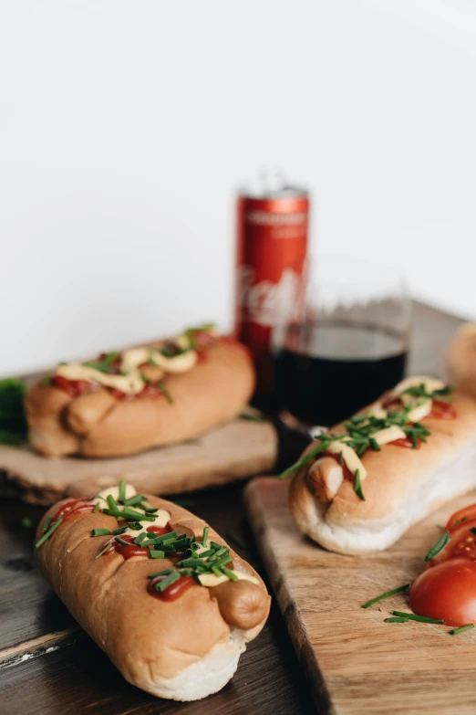 a couple of hot dogs sitting on top of a cutting board, nuka cola, profile image, alessio albi, loaves