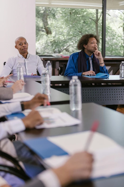 a group of people sitting around a conference table, paris school, ashteroth, thumbnail, multiple stories, wim crouwel