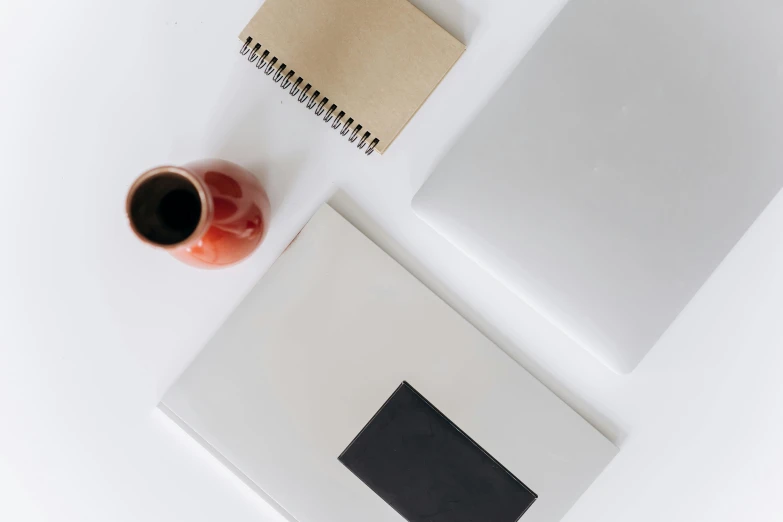 a cup of coffee and a notebook on a table, trending on unsplash, minimalism, 9 9 designs, white minimalist architecture, fan favorite, rectangle