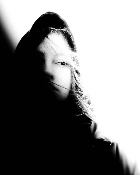 a black and white photo of a woman's face, an album cover, by Caroline Mytinger, in a black hoodie, overexposed sunlight, young child, kirsi salonen