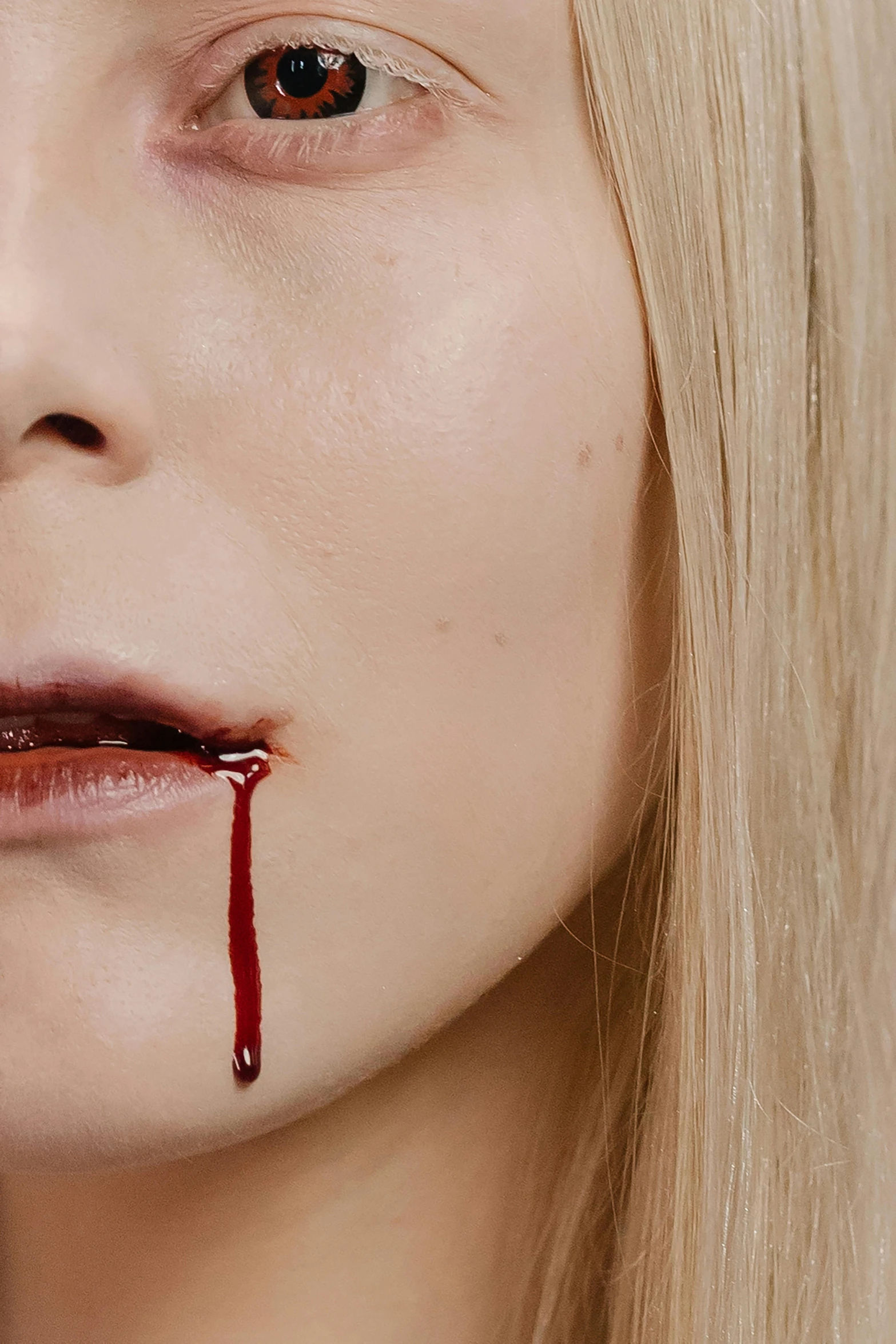 a close up of a woman with blood on her face, an album cover, inspired by Gottfried Helnwein, trending on pexels, renaissance, close up of a blonde woman, eating, male vampire, blood tears