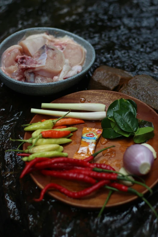 a close up of a plate of food on a table, patiphan sottiwilaiphong, kete butcher, ingredients on the table, first light