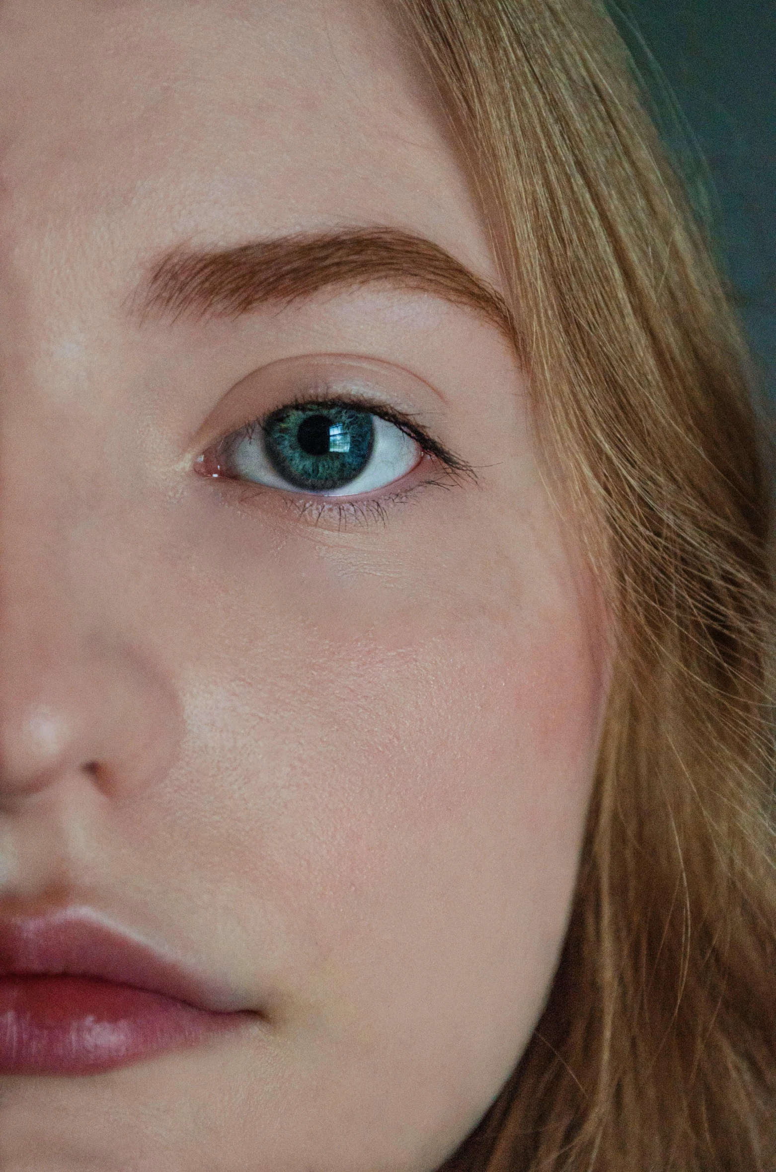 a close up of a woman with blue eyes, a photorealistic painting, inspired by Elsa Bleda, trending on pexels, photorealism, eyebrow scar, hyperrealistic teen, high angle closeup portrait, low - angle shot