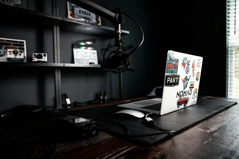 a laptop computer sitting on top of a wooden desk, pexels, video art, table with microphones, film lighting, fully decorated, avatar image