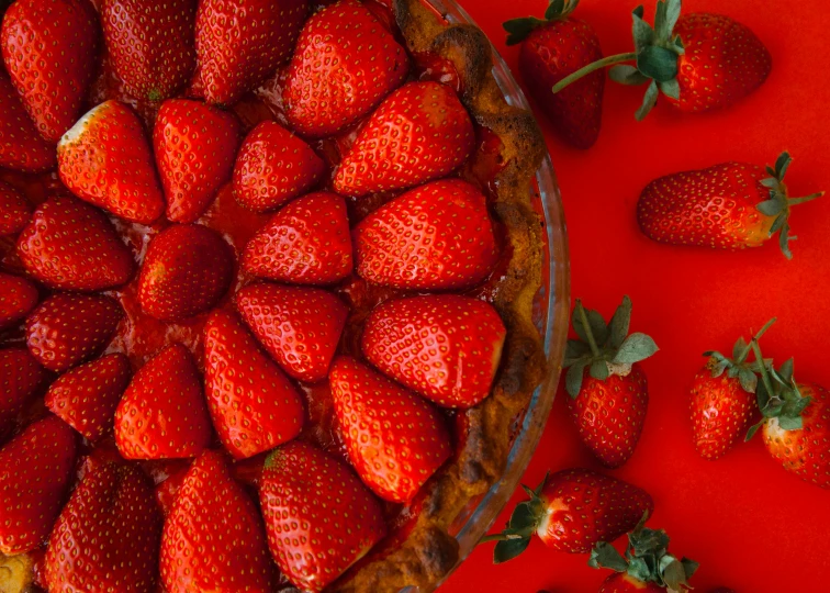 a pie topped with lots of strawberries on top of a red table, pexels contest winner, 🦩🪐🐞👩🏻🦳, maxim shirkov, strawberry fields forever, essence