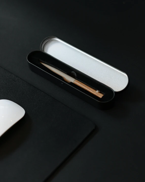 a close up of a mouse on a desk, inspired by Zaha Hadid, minimalism, engraved blade, inside its box, matte finish, product introduction photo