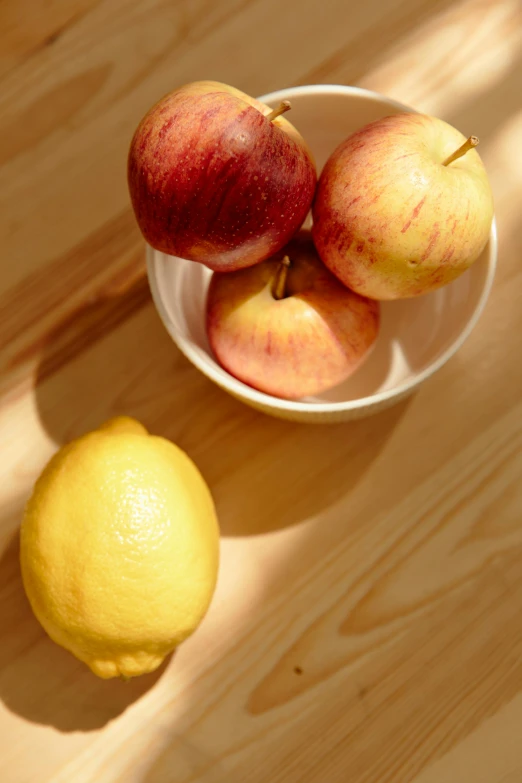 a bowl of apples and a lemon on a table, promo photo, in detail, 4l, mix