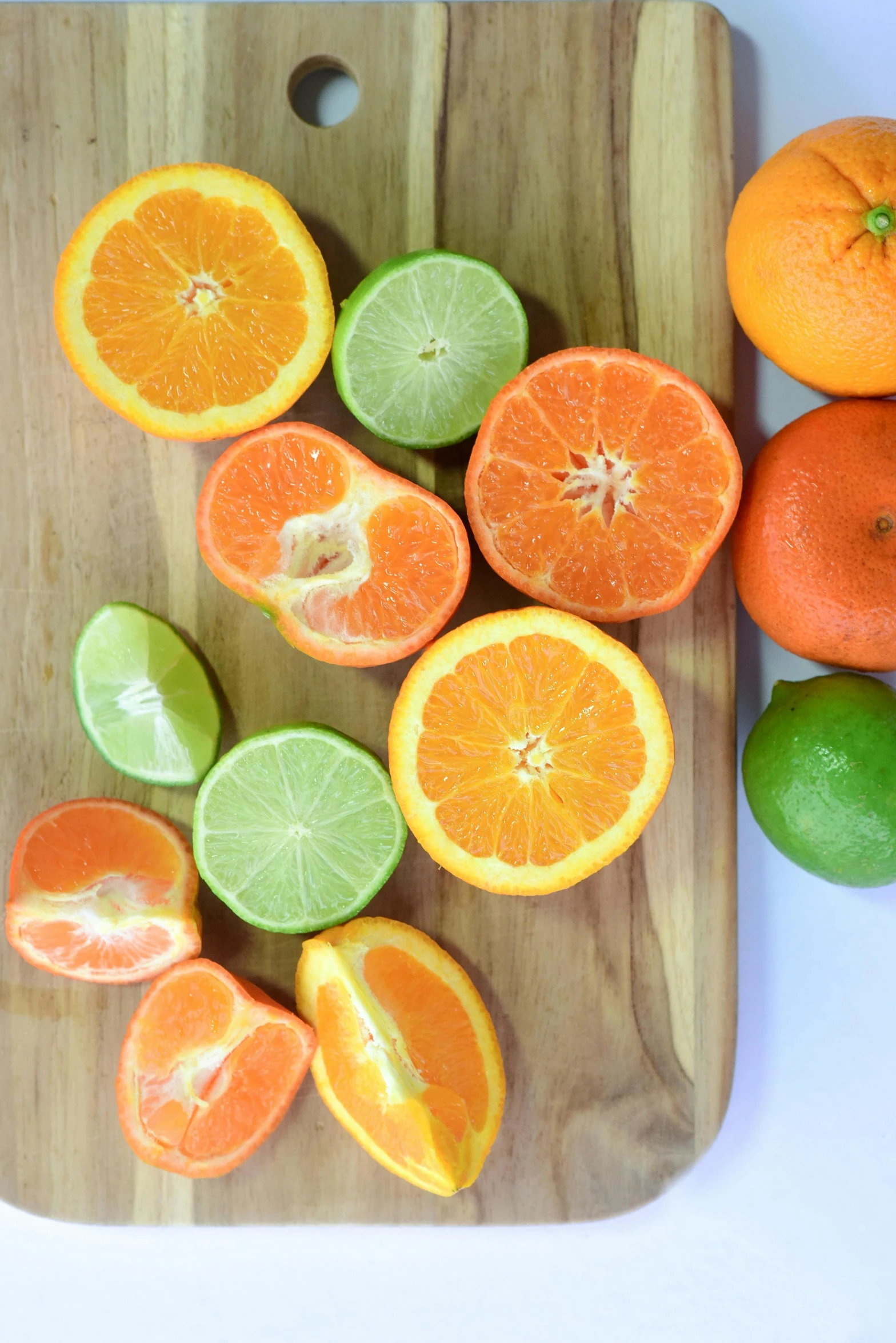 a cutting board with oranges and limes on it, mix, vibrantly lush, sweet, organics