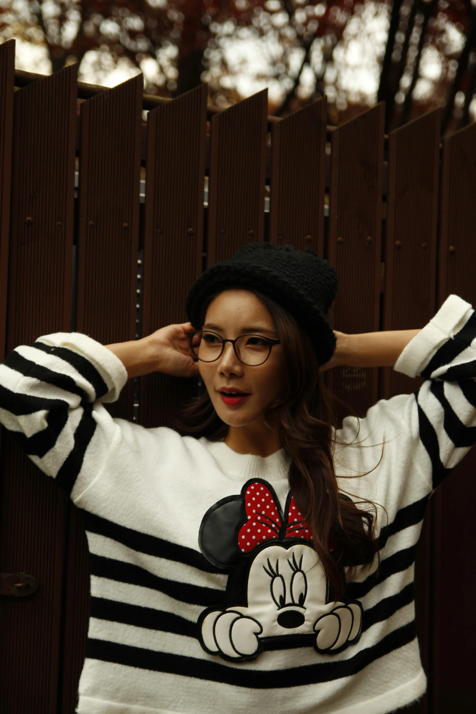 a woman wearing glasses and a mickey mouse sweater, inspired by Tang Sin Yun Sandara, unsplash, black stripes, square, 256435456k film, posing for a picture