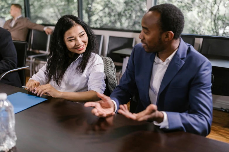 a group of people sitting around a conference table, pexels contest winner, sydney park, two people, smiling at each other, teaching