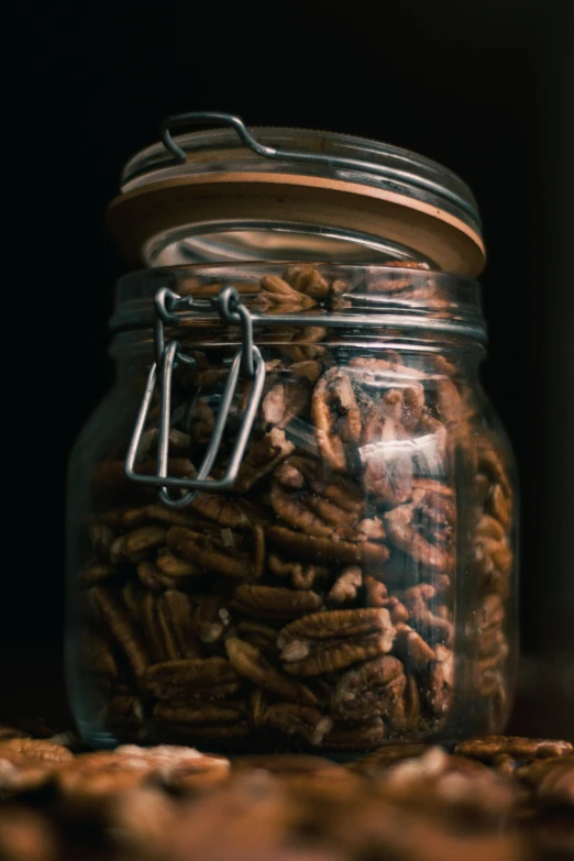 a jar filled with nuts sitting on top of a table, thumbnail, hot food, detailed product image, detail shot