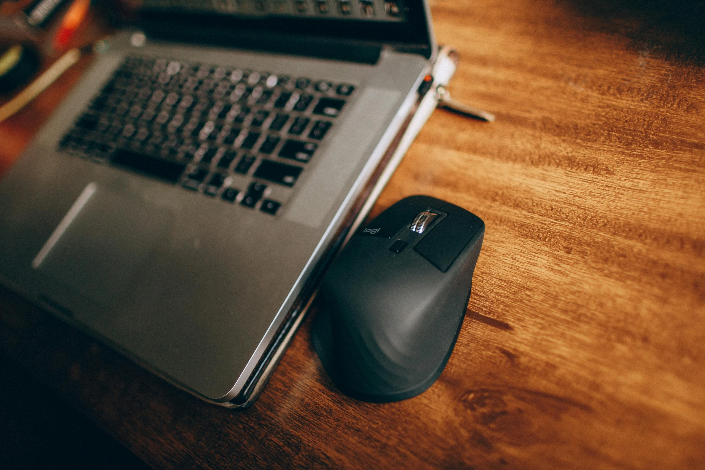 a laptop computer sitting on top of a wooden desk, scrolling computer mouse, shot with sigma f / 4. 2, thumbnail, curved