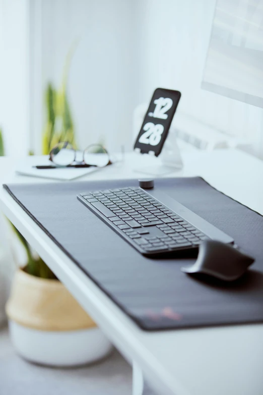 a laptop computer sitting on top of a white desk, on a table