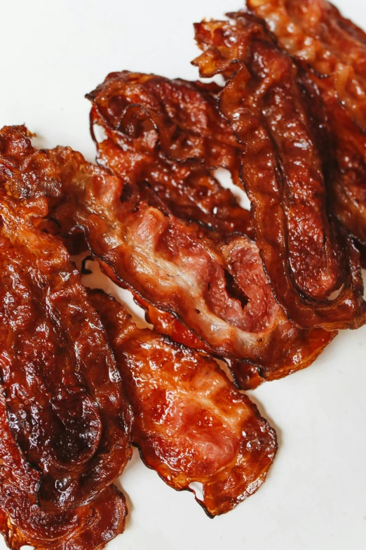 a pile of bacon sitting on top of a white plate, profile image, malaysian, bts, up-close