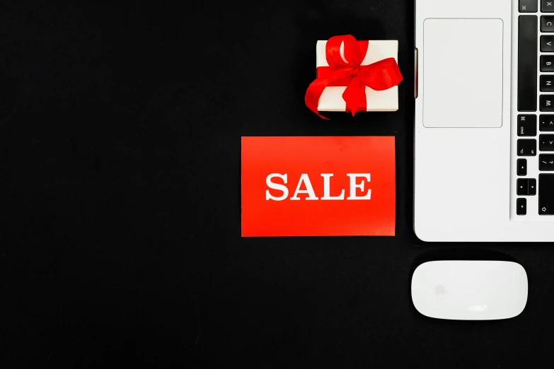 a laptop computer sitting on top of a desk, a photo, sales, red on black, square, presents