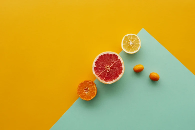 grapefruits, lemons and oranges on a blue and yellow background, by Andries Stock, trending on pexels, turquoise and orange, minimalist wallpaper, scarlet and yellow scheme, grey orange