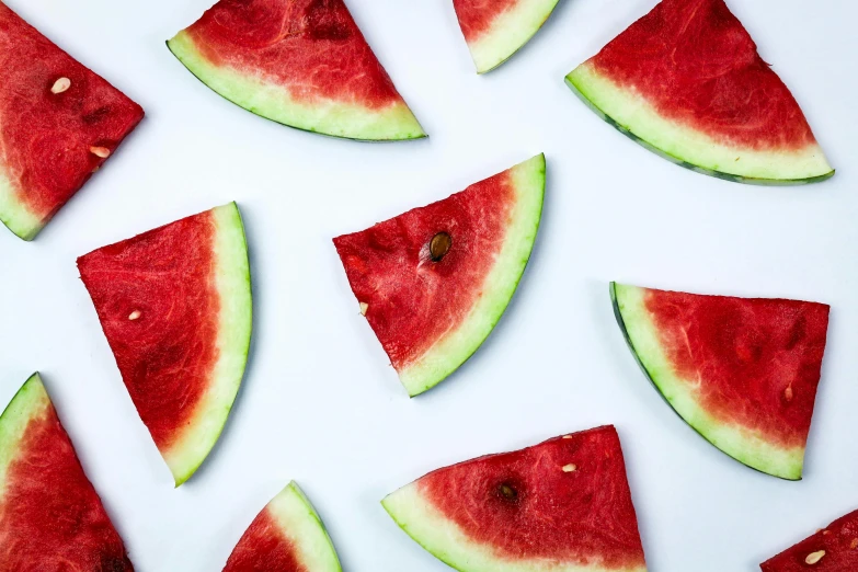 a group of slices of watermelon on a white surface, by Carey Morris, trending on unsplash, hurufiyya, 🎀 🗡 🍓 🧚, hydration, background image, graphic print