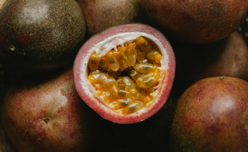 a close up of a passion fruit cut in half, trending on pexels, brown, grey, puce and vermillion, waist high