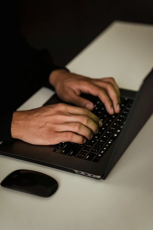 a close up of a person typing on a laptop, pexels, a man wearing a black jacket, man steal computers, plain background, multiple stories