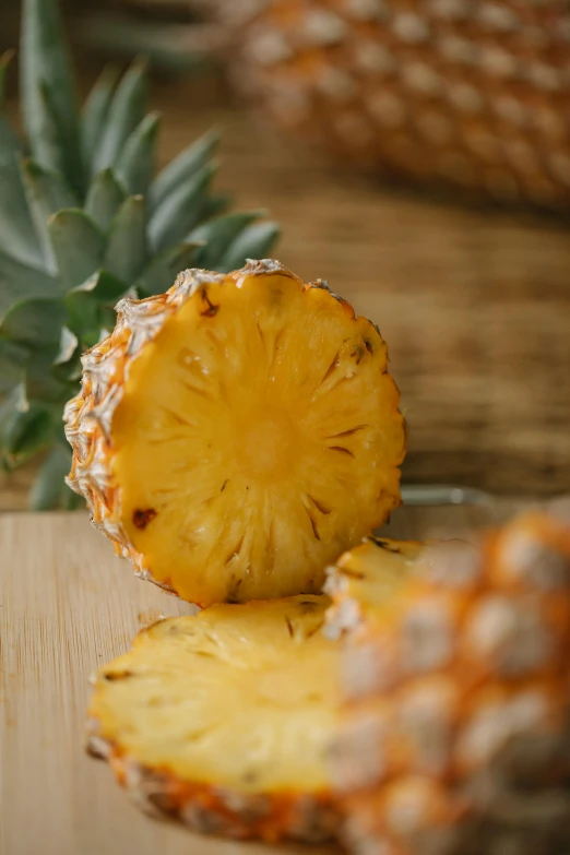 a pineapple cut in half on a cutting board, award-winning crisp details”, botanicals, amber, up close