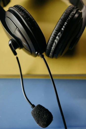 a pair of headphones sitting on top of a table, pexels, computer art, ap photo, multiple stories, schools, up close picture