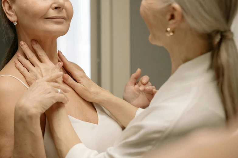 a close up of a person touching a woman's chest, a photo, by Gavin Hamilton, pexels contest winner, renaissance, doctors mirror, graceful and elegant, older woman, behind the scenes photo