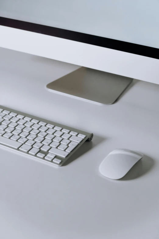 a desktop computer sitting on top of a white desk, silver accessories, press shot, mouse, dezeen