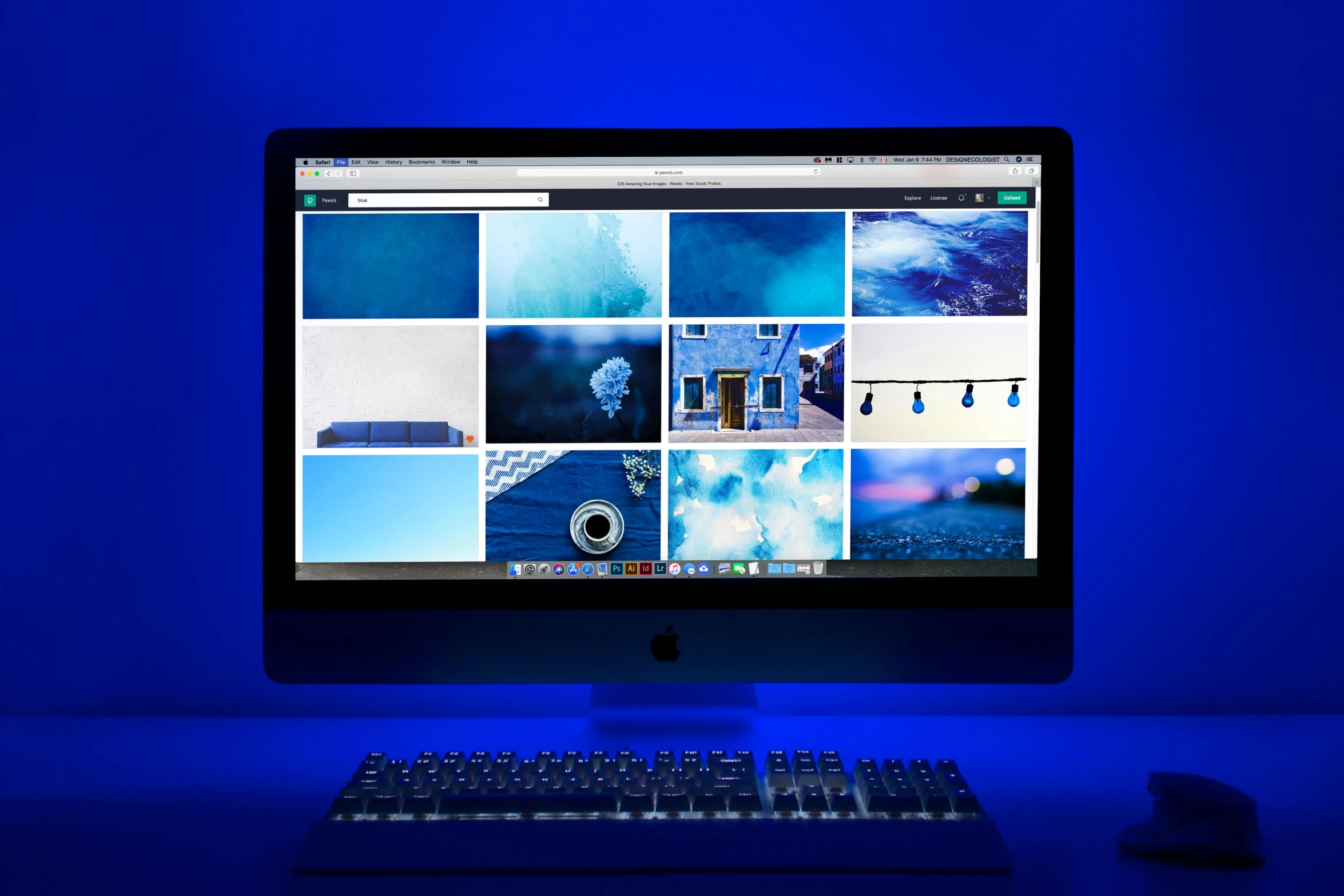 a computer monitor sitting on top of a desk, a computer rendering, by Julia Pishtar, unsplash, computer art, blue themed, photo mosaic, everything fits on the screen, blue lighting