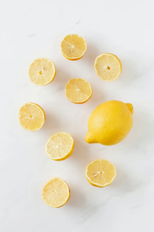 a bunch of lemons sitting on top of a table, smooth marble surfaces, light scatter, 6 pack, mild