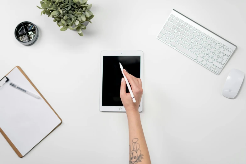 a person holding a pen and writing on a tablet, trending on pexels, arbeitsrat für kunst, 9 9 designs, sleek white, rectangle, fan favorite