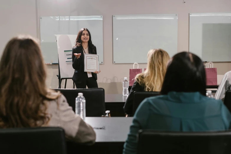 a woman giving a presentation to a group of people, profile image, worksafe. instagram photo, professional model, tiffany dover