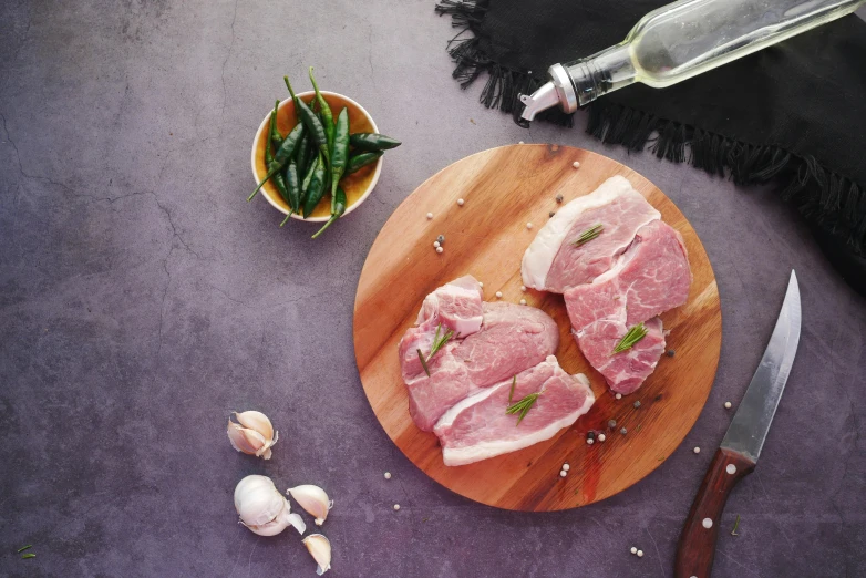a cutting board topped with meat next to a knife, a picture, grey, full product shot, thumbnail, cosmopolitan