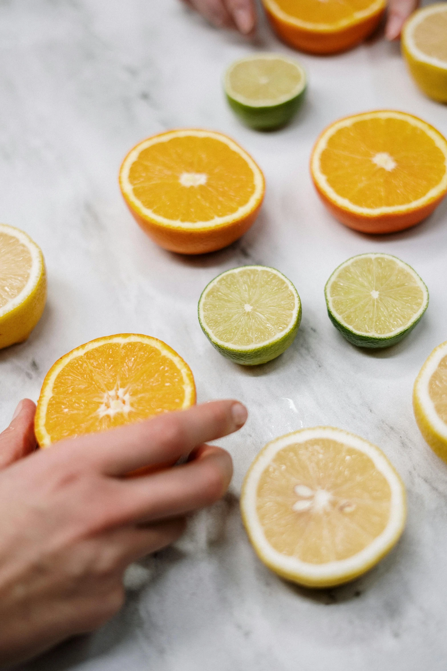 a table topped with sliced oranges and limes, trending on pexels, process art, partially cupping her hands, grey, pastel', multiple stories