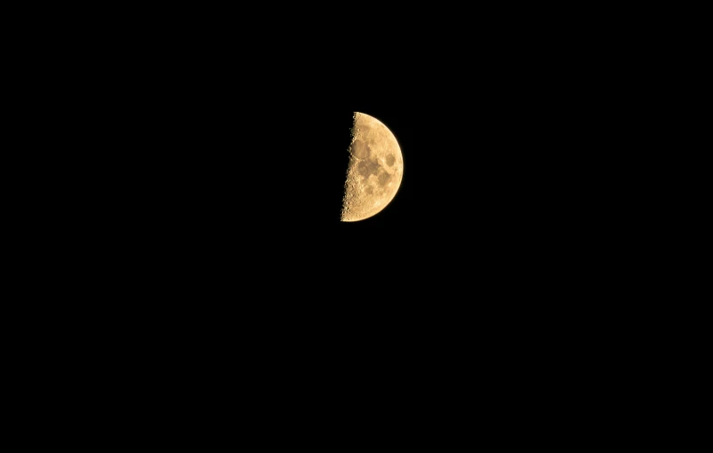 a half moon is seen in the dark sky, minimalism, sandman, ❤🔥🍄🌪, gold, f / 1. 2 5