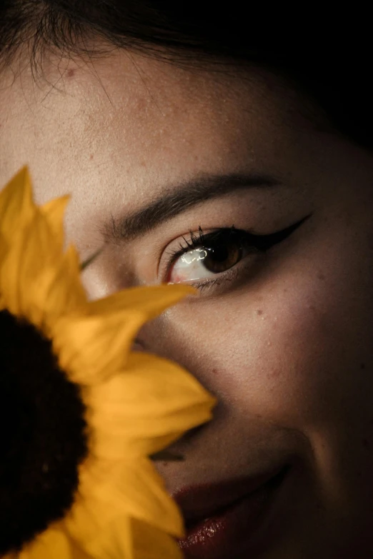 a woman holding a sunflower in front of her face, inspired by Xie Sun, pexels contest winner, minimalism, gazing dark brown eyes, ((portrait)), cinematic closeup, chinese woman