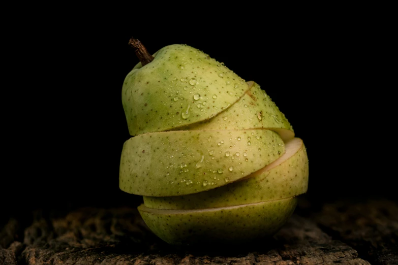 a green apple sitting on top of a piece of wood, on a wooden table, avatar image, stacked image, lpoty