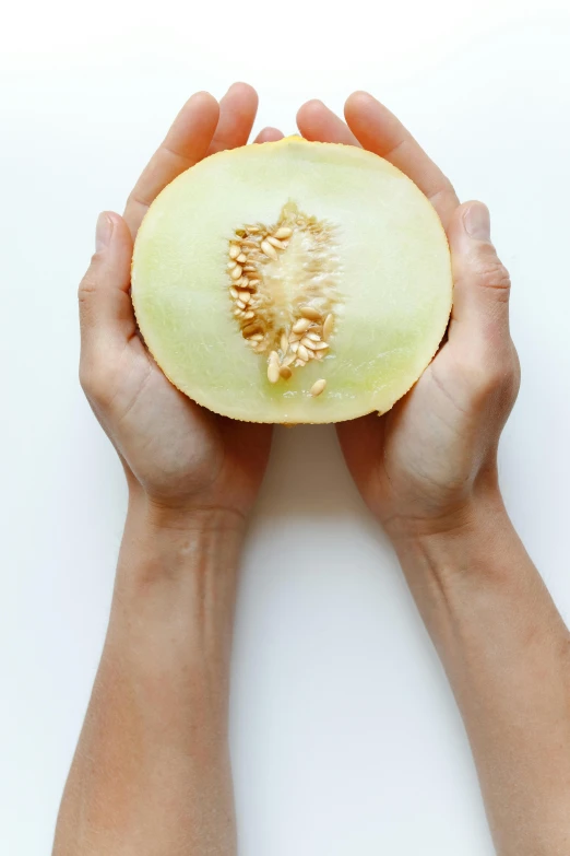 a person holding a half of a melon, by Matthias Stom, unsplash, renaissance, on clear background, asian origin, sleek hands, petite pear slim figure