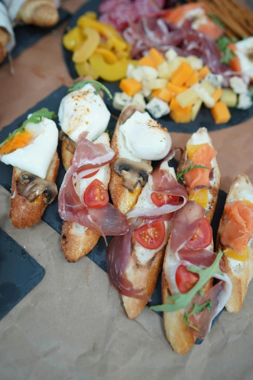 a table topped with lots of different types of food, mozzarella, up-close, overview, square