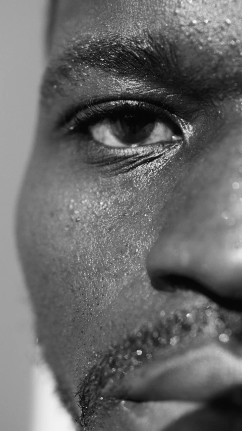 a black and white photo of a man's face, by Maxwell Bates, pexels, sweating profusely, close up shot from the side, man is with black skin, 16k upscaled image