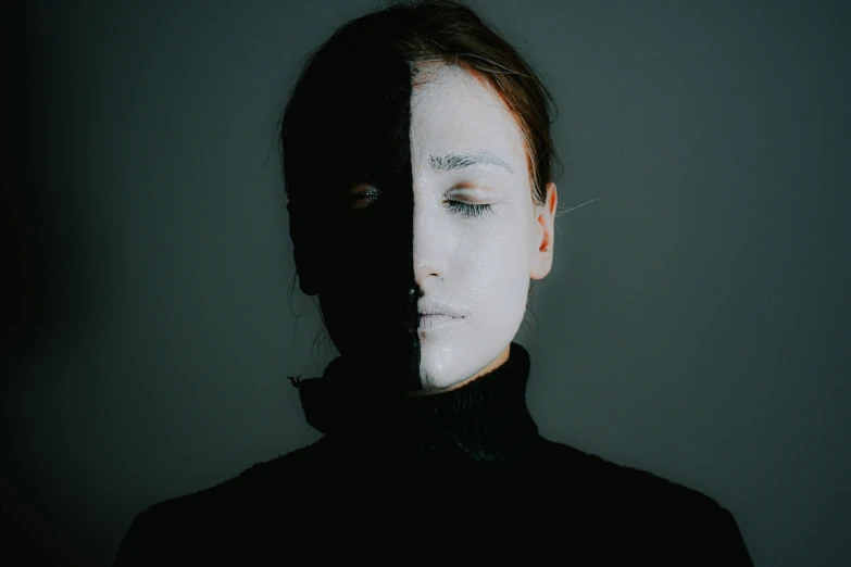 a woman with white paint on her face, a black and white photo, pexels contest winner, antipodeans, image split in half, shadowy, symmetrical head and body, realistic person