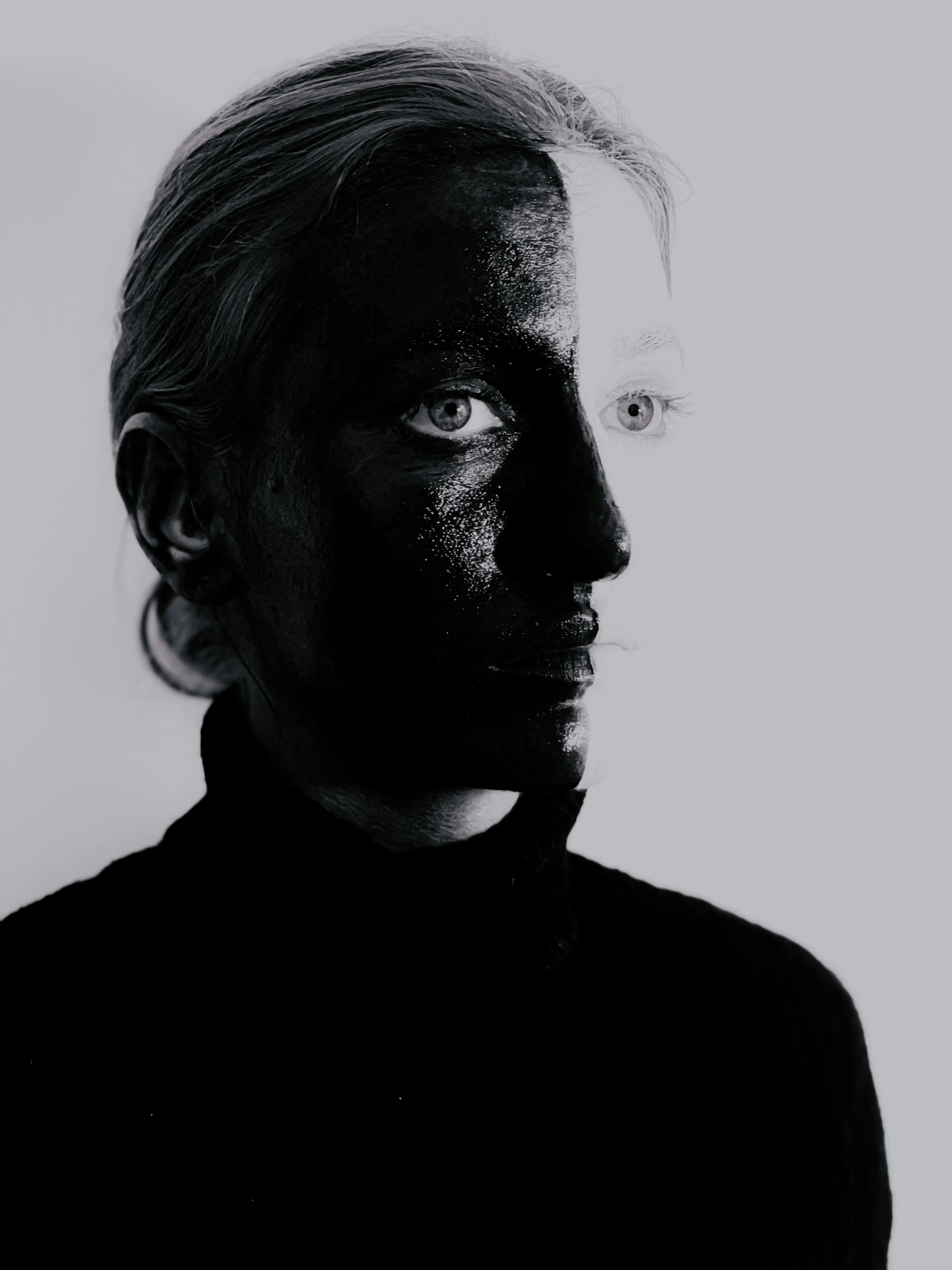 a man with black paint on his face, a black and white photo, by Ignacy Witkiewicz, johan liebert, made of smooth black goo, julia hetta, alternate album cover