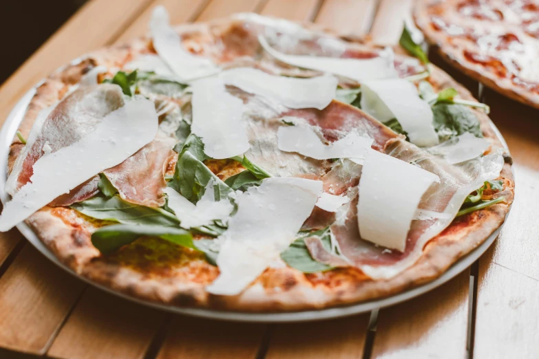 two pizzas sitting on top of a wooden table, by Carey Morris, pexels contest winner, pink white and green, ivy's, profile image, fresco