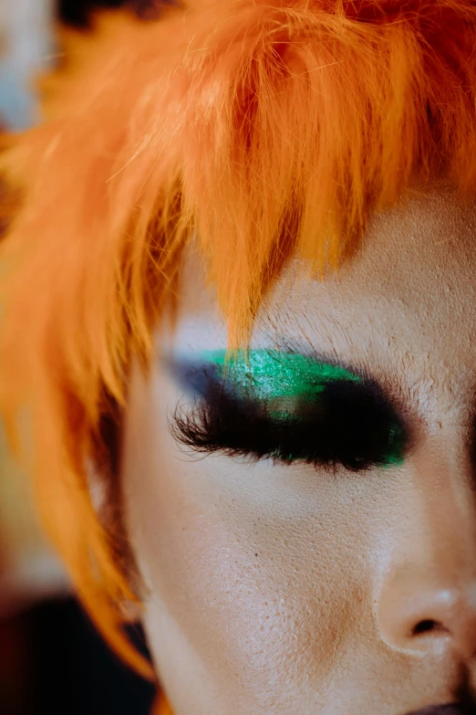 a close up of a person with orange hair, an album cover, inspired by Cindy Sherman, trending on pexels, eye color green, kabuki makeup, ((greenish blue tones)), drag queen