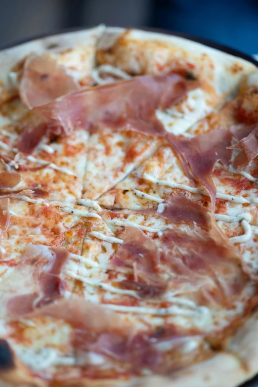 a pizza sitting on top of a pan on a table, by Robbie Trevino, ap, ham, local close up, piroca