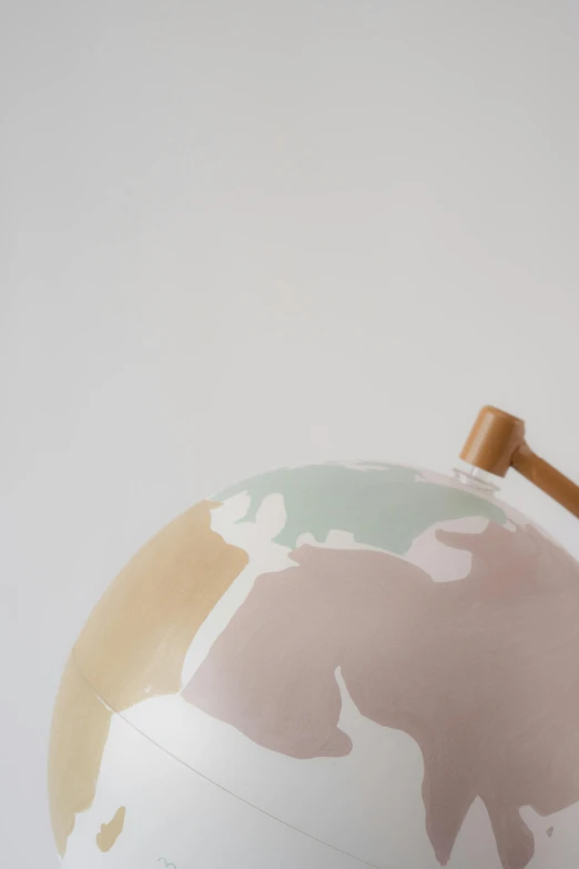 a close up of a globe on a table, an abstract sculpture, by Will Ellis, modern studio light soft colour, pastel palette silhouette, watering can, professionally assembled