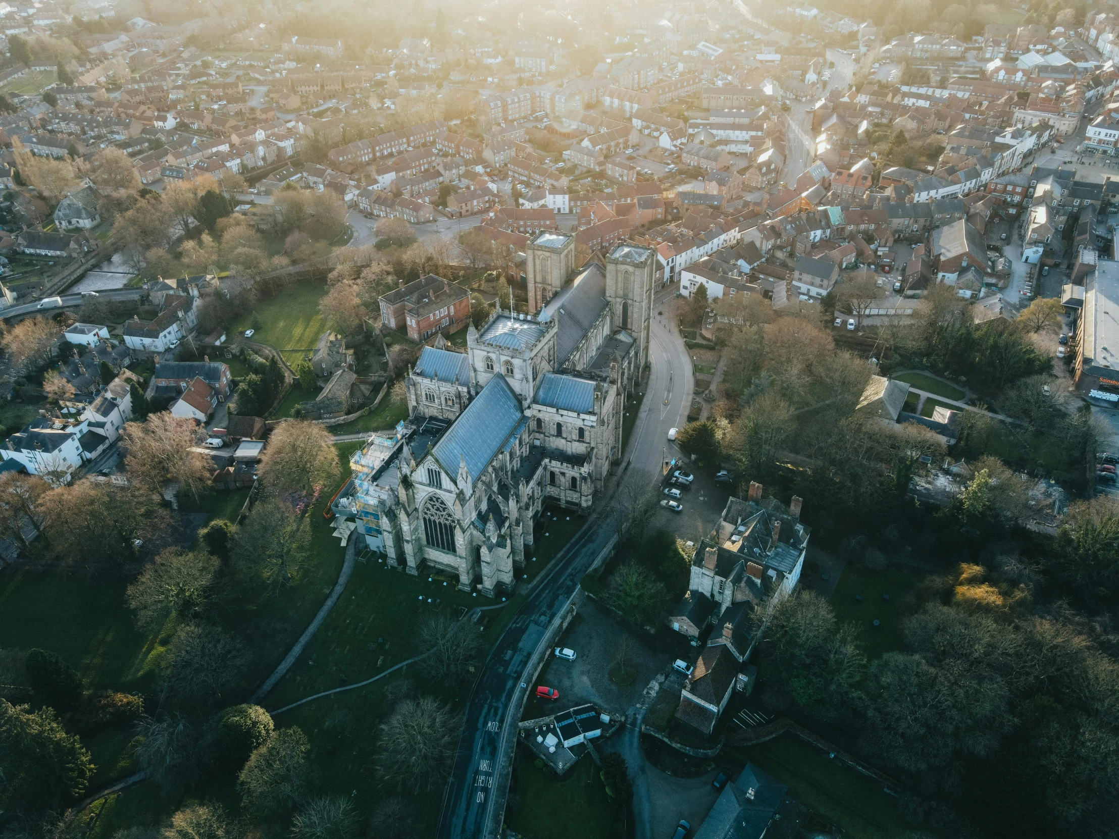 a view of a city from a bird's eye view, by IAN SPRIGGS, pexels contest winner, photographic isometric cathedral, abbeys, late afternoon light, aerial view cinestill 800t 18mm