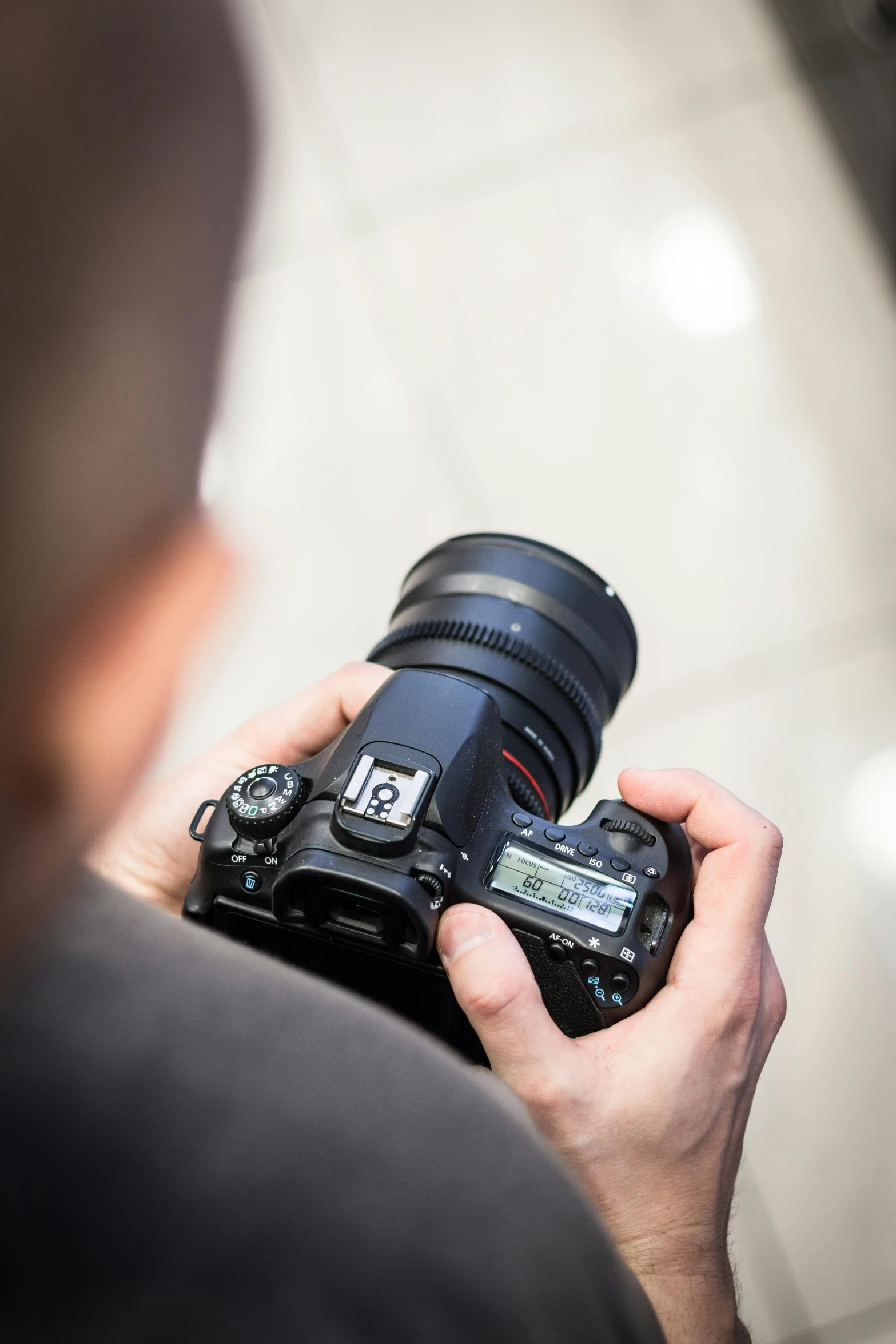 a close up of a person holding a camera, a picture, canon eos 90d, 1 0 8 megapixels, a high angle shot, hasselblade shot