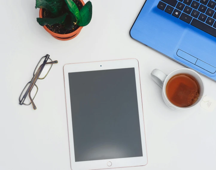 a tablet computer sitting on top of a table next to a cup of coffee, trending on pexels, square rimmed glasses, professional iphone photo, maintenance photo, white backround