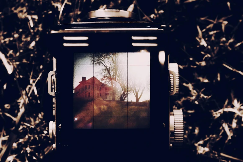 a close up of a camera with a house in the background, inspired by Diane Arbus, unsplash, art photography, medium format, vintage horror, hasselblad medium format, multiexposure